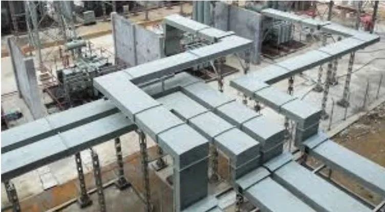 Overhead bus duct runs above electrical equipment at an industrial site