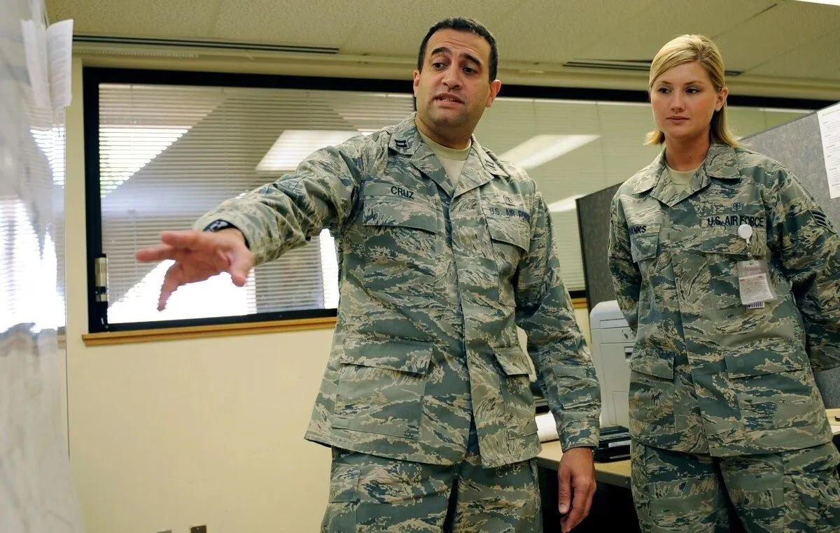 Captain David Cruz in Air Force uniform briefing an airman in an office