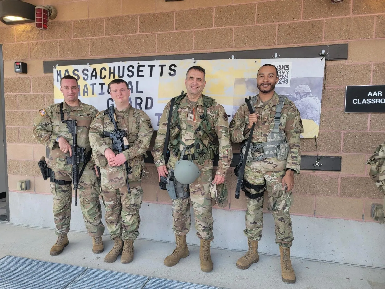 Lieutenant Colonel David Cruz with Air Force and Army personnel in field gear at a National Guard training site