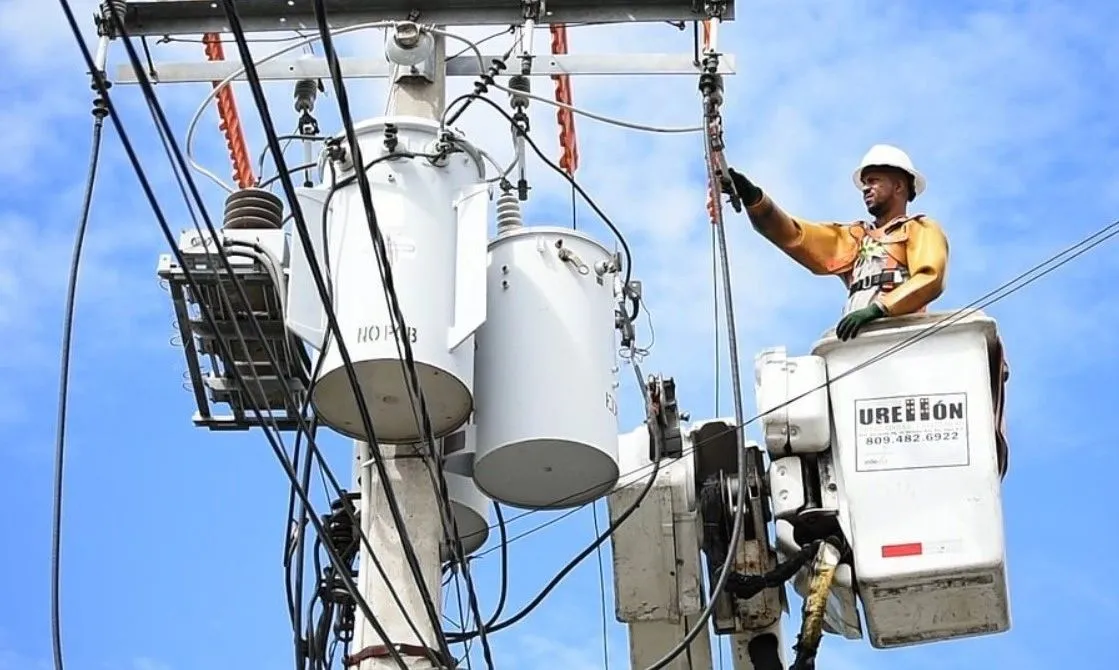 Electrician terminating conductors inside a distribution panel