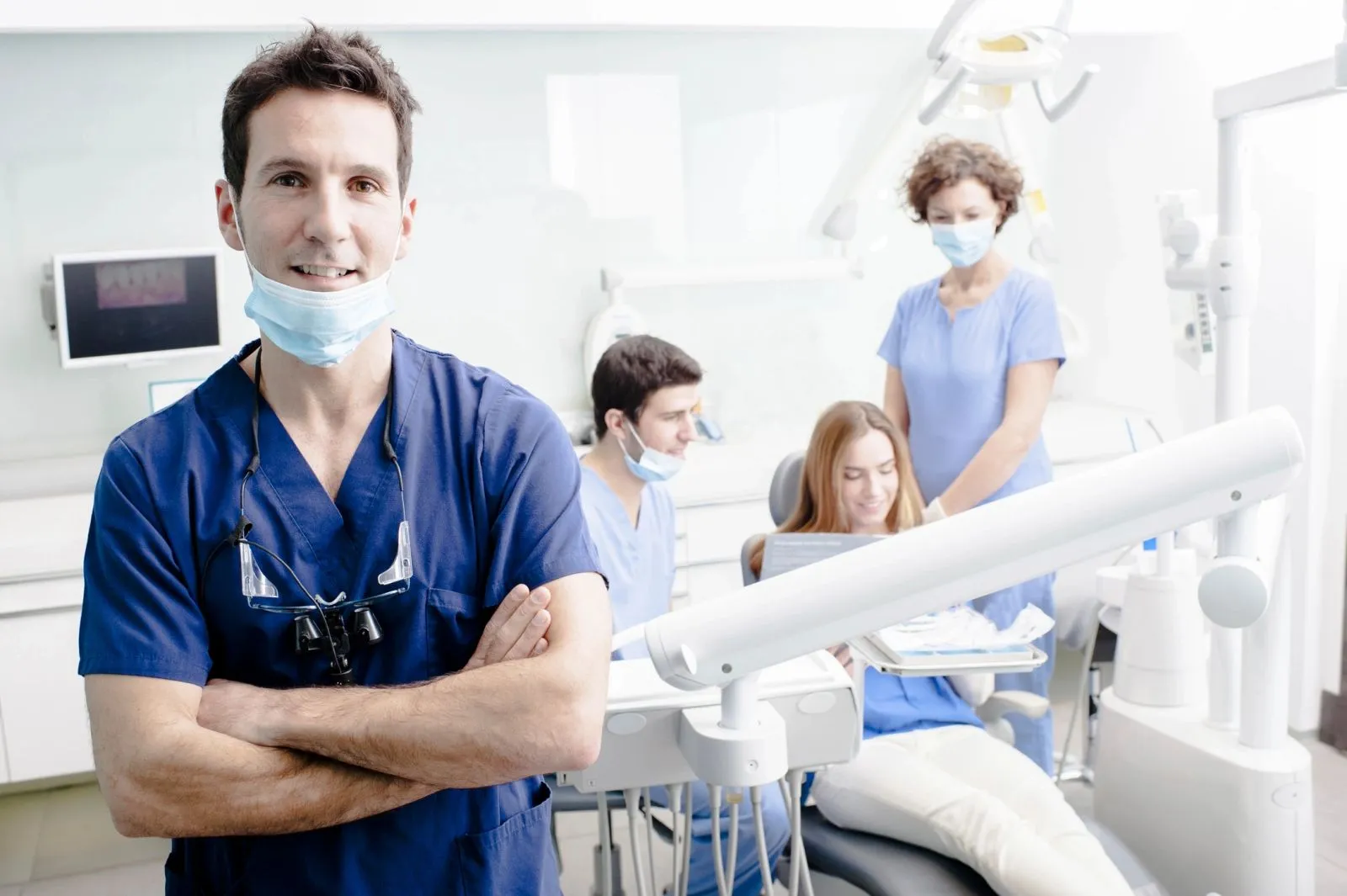 Dentist and clinical staff in a modern treatment room