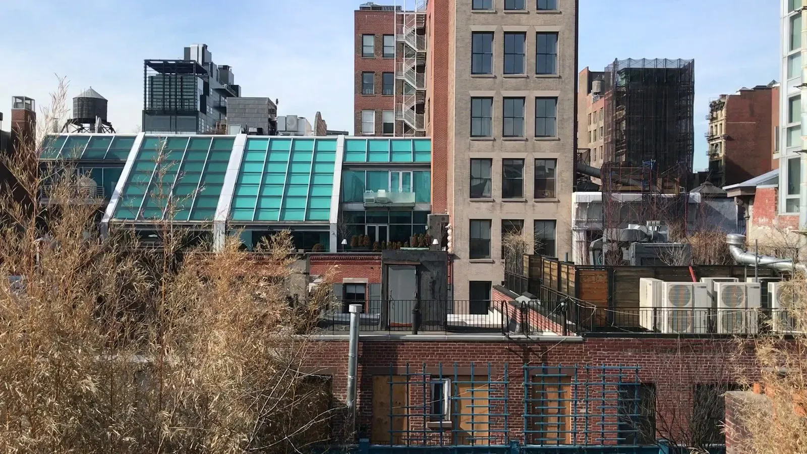 Rooftop condensing units, ductwork and piping on adjacent city buildings