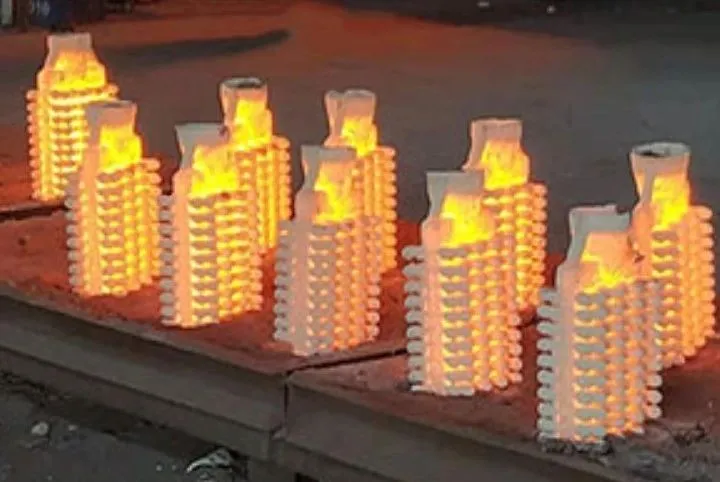 Glowing investment casting shells on a foundry floor