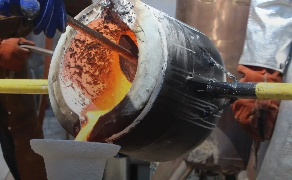 Glowing investment casting shells cooling on a foundry floor