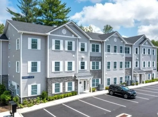 Three story apartment building with grey siding at a Connecticut development